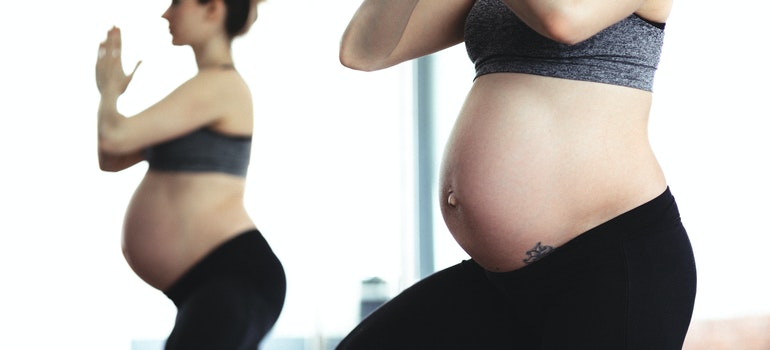 A woman doing yoga while pregnant since Crossfit and pregnancy together aren't the best choice for her.