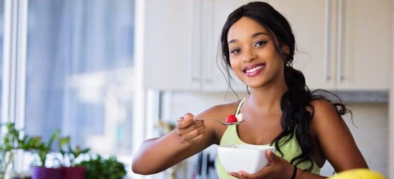 A woman eating a healthy meal.