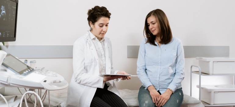 A pregnant woman talking to her OB/GYN
