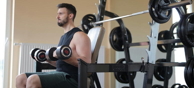 man lifting dumbbells