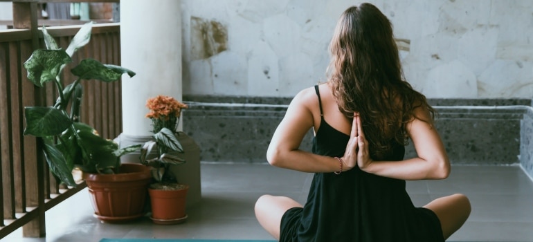 a woman practicing yoga on a balcony