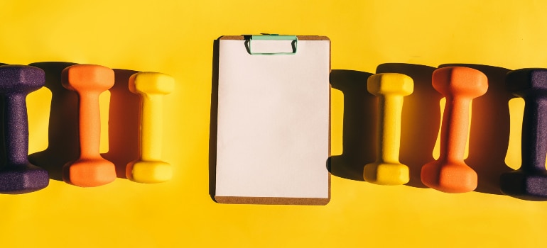 dumbbells and exercise planner to crush your fitness goals