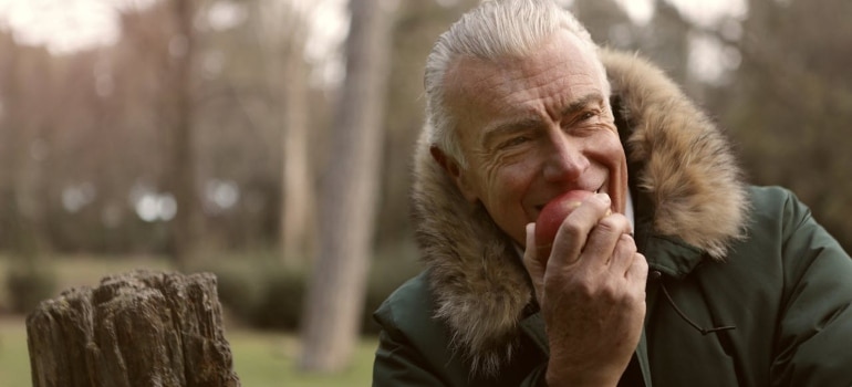 a senior eating an apple