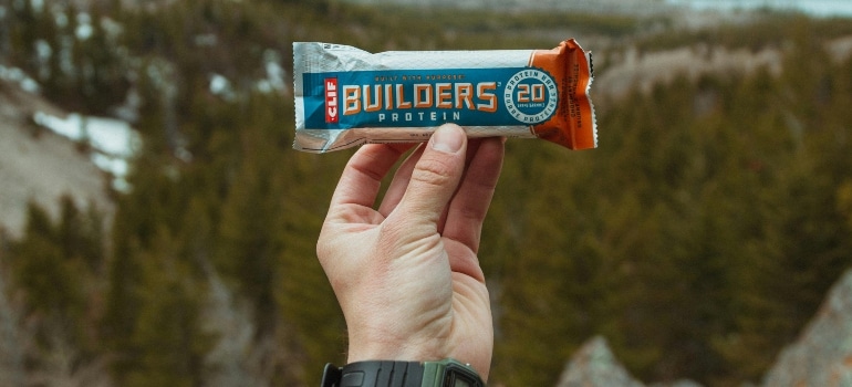 A person holding a protein bar