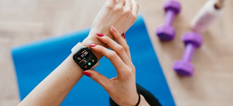 A woman checking her smart watch after reading tips on how to improve your circadian clock.
