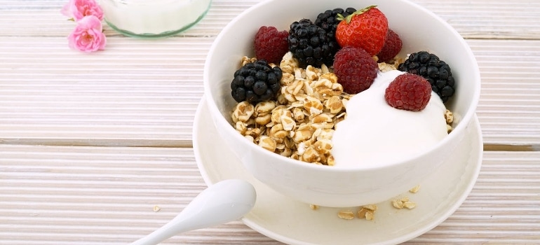 Oats in a bowl with berries and greek yogurt.