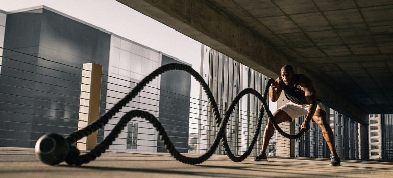 A man doing a rope workout.