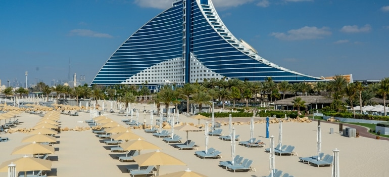Building and sunbeds at Jumeirah Beach, which is among the best beaches for water sports and fitness in Dubai. 