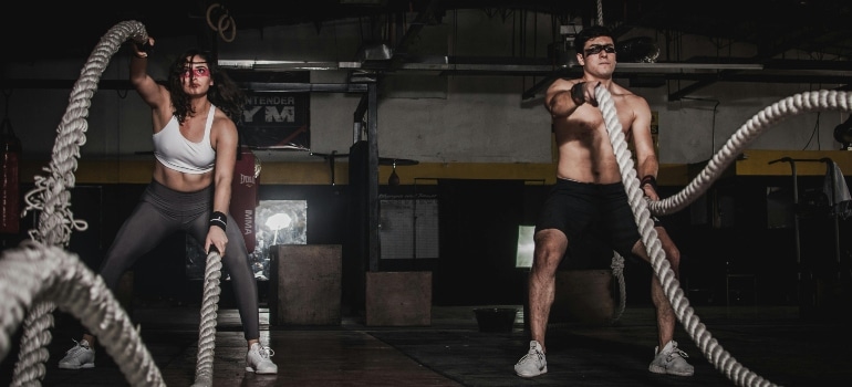 A woman and a man working out and wondering 