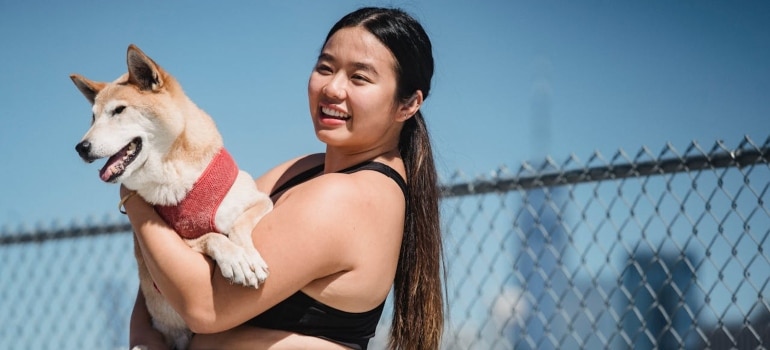 a girl holding a dog