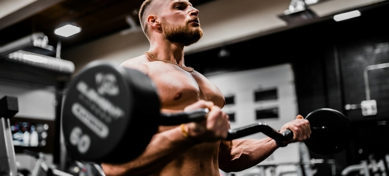 A bodybuilder is lifting weights.