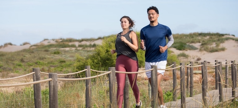 a man and a woman jogging outdoors