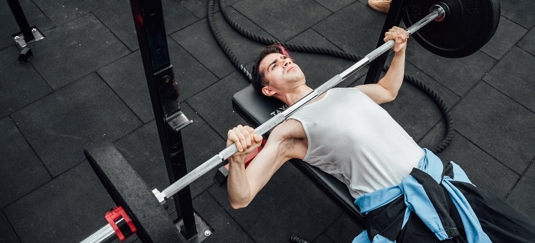 A man is doing the bench press.