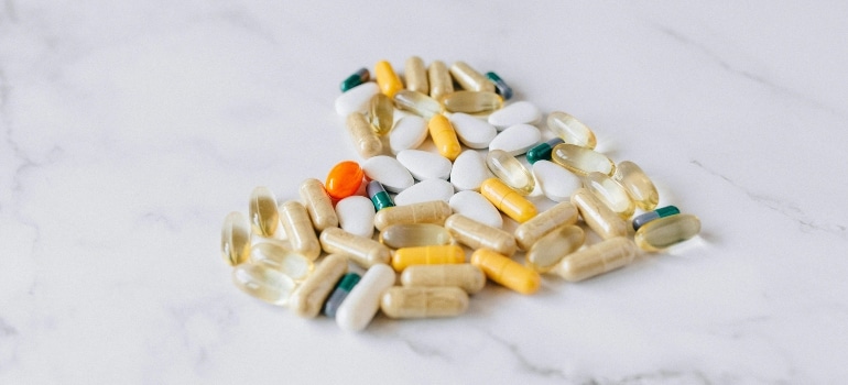 Supplements and vitamins on a white surface