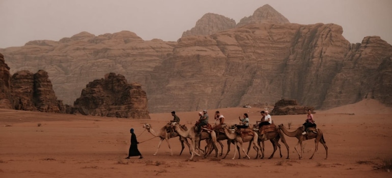 people riding through the desert