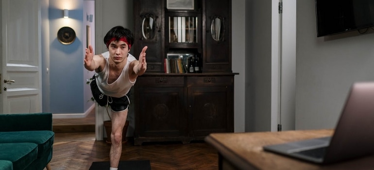 a man exercising at home, trying out a 15 minute daily workout plan