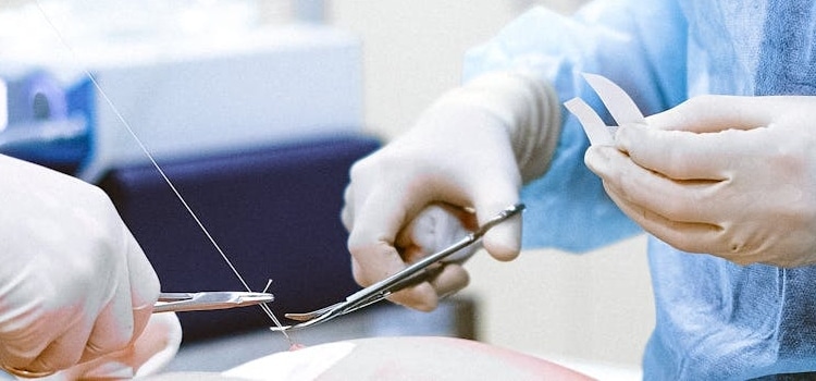 surgeons operating a patient that chose plastic surgery after debating whether fitness vs. plastic surgery is the answer