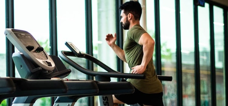 a man doing cardio exercise after choosing fitness vs. plastic surgery