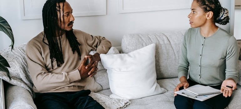 A man sitting on the couch talking to a nutritionist