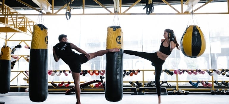 Man and woman practicing kickboxing.