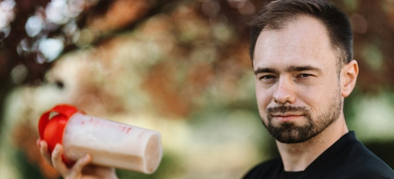 A man holding a protein smoothie