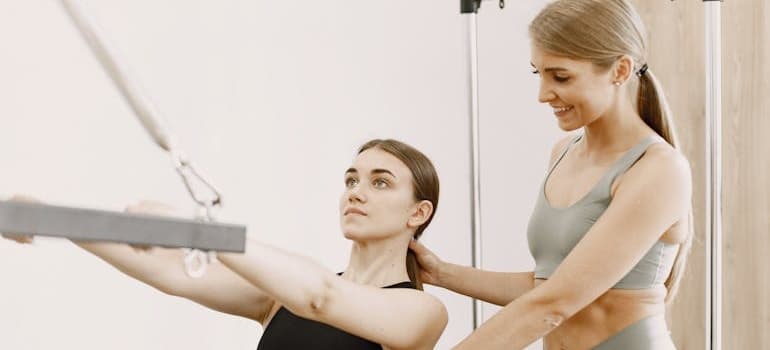 A woman training with a personal trainer.