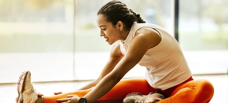 A woman stretching on the floor.