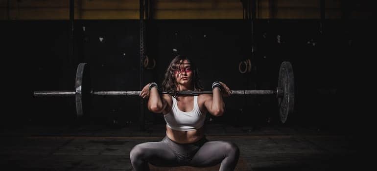 A woman doing a strength training in a gym.