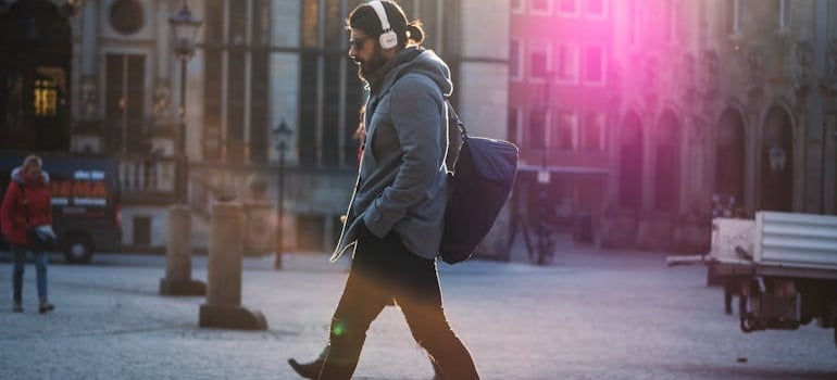 A man walking around a city center.
