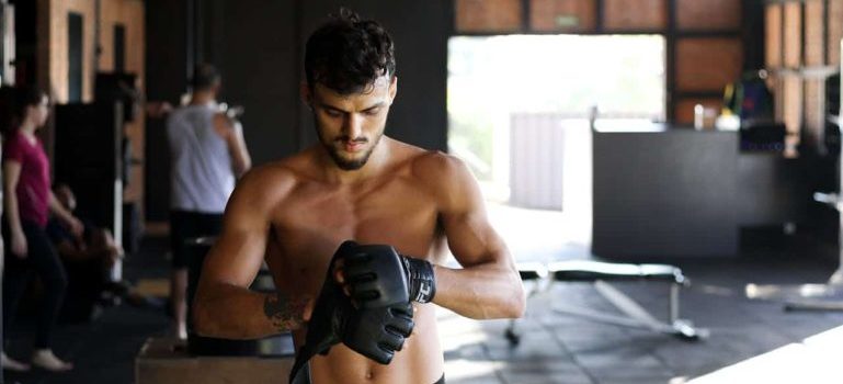 man wearing black boxing gloves