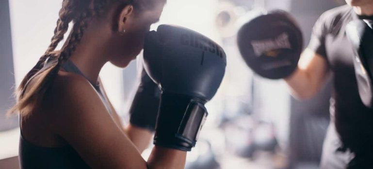 woman wearing black boxing gloves