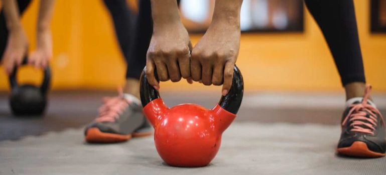 person exercising with kettlebell