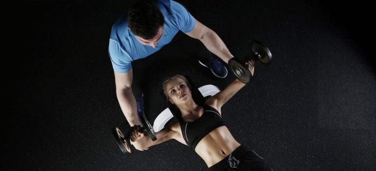 A woman lying on bench press and following the best fitness tips for women