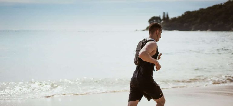 man jogging on seashore