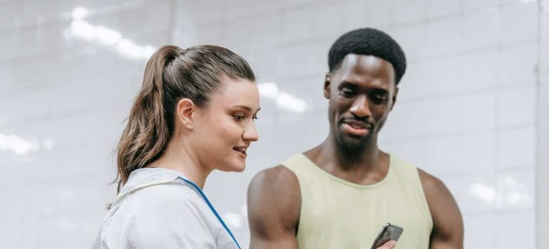 woman and man looking at smartphone