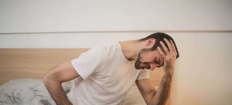 man holding his head 