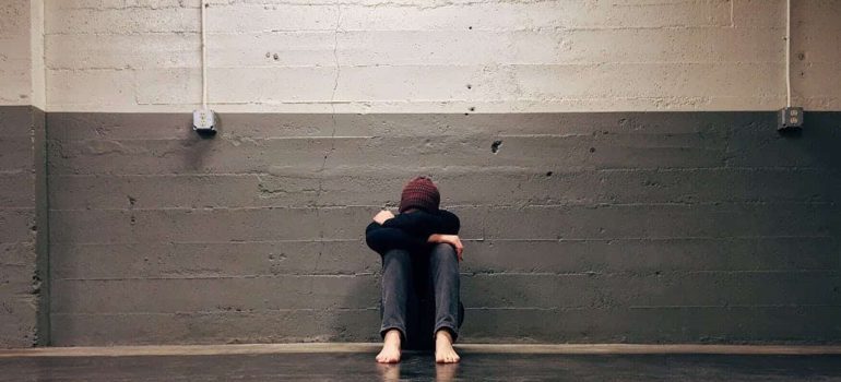 person leaning on wall