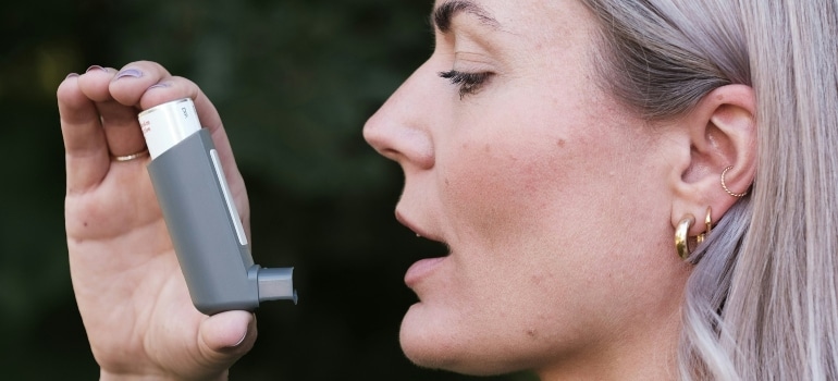 Person using an inhaler