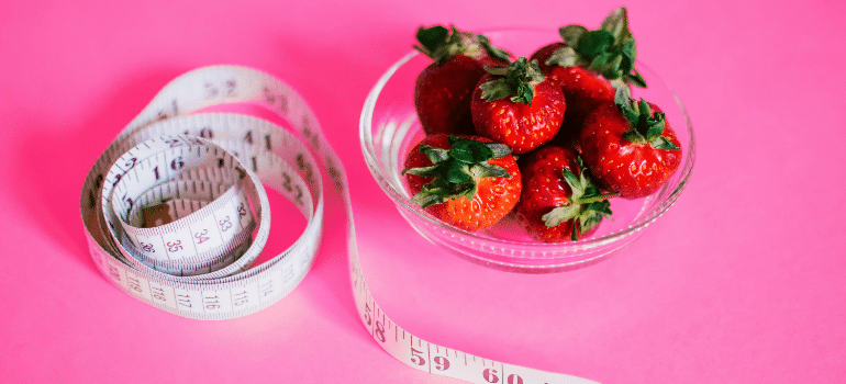 A measuring tape and strawberries