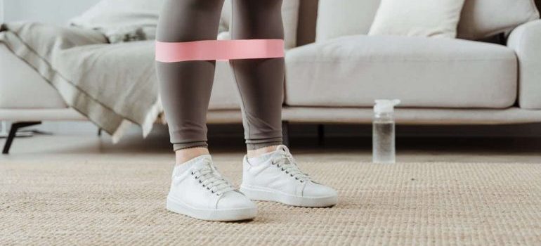 A woman using a feet band to exercise