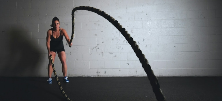 Person following the tips for staying fit on a budget in Dubai and doing CrossFit