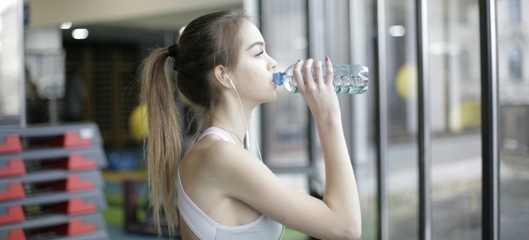 A person drinking water from a bottle