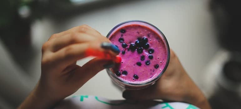 A person holding a smoothie