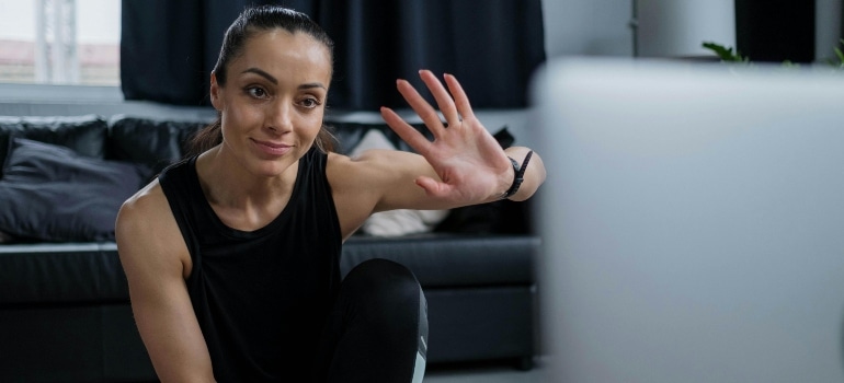 A woman communicates with her personal trainer in Dubai via online session.