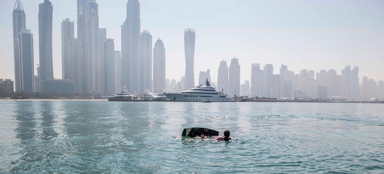 Person looking at the skyline while enjoying water sports in Dubai