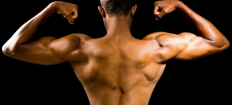 Person flexing after using one of the 5 quickest ways to build muscle mass