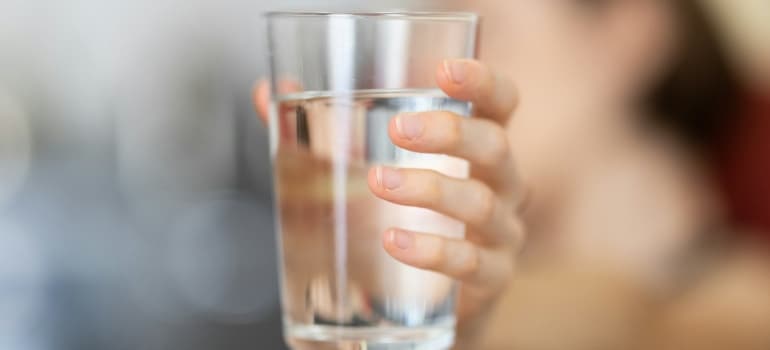 Person holding a glass of water
