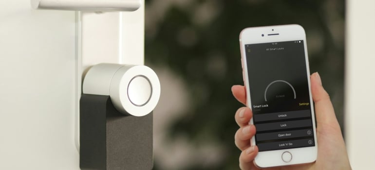 Person using smart home gadgets to build a home environment that supports healthy living