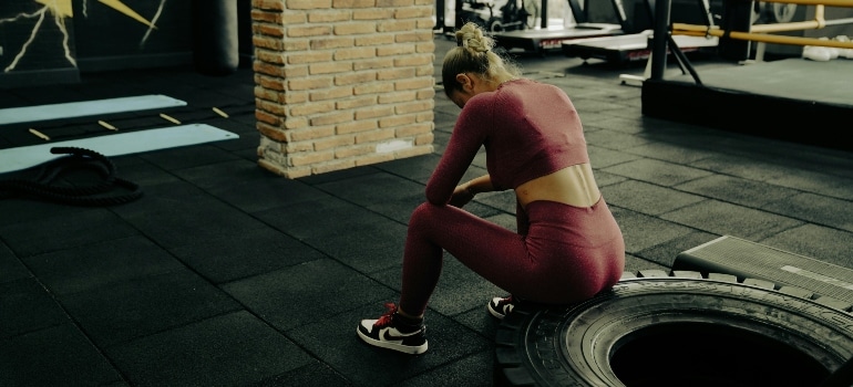 A tired person in a gym.